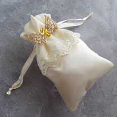 Satin Pouch with Lace Skirt is embellished with Wings and Cross. It's classic with ethereal feel. Best for Baptism, First Communion, Confirmation, Birthdays, Religious Gifts, Baby Shower Available in 3 Colors: 1. White Pouch with White Wings and Silver Cross 2. Ivory Pouch with Ivory Wings and Gold Cross 3. Ivory Pouch with Gold Wings and Gold Cross Size: 6x4 Order quantity: 10 pcs per pack Elegant White Embroidered Baptism Dress, Elegant Gold Baptism Dress, Elegant Cream Embroidered Baptism Dress, Elegant Beige Baptism Dress For Wedding, Satin Pouch, White Wings, Gifts Baby, Gold Cross, Religious Gifts