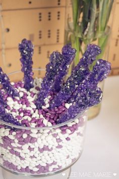 purple and white flowers in a glass vase