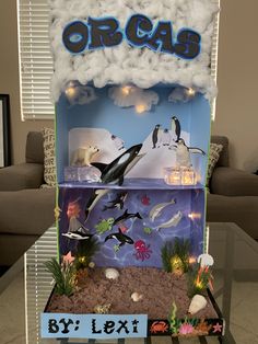 an orca display in the living room with lights and fake sea animals on it