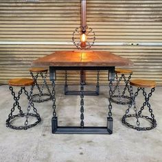 a table with four stools and a lamp on it in front of a garage door