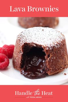 chocolate lava brownies on a white plate with raspberries