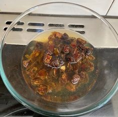 a glass bowl filled with food on top of a stove