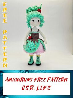 a crocheted doll with green hair wearing a dress