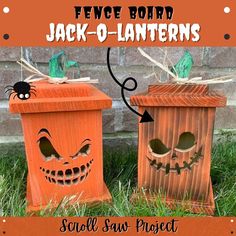 two pumpkin boxes with faces on them sitting in the grass