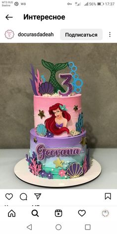 a three tiered cake with ariel the mermaid on top