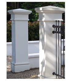 two tall white pillars next to each other