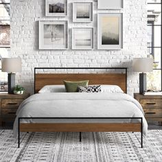 a bedroom with white brick wall and wooden bed frames on the wall, along with multiple nightstands