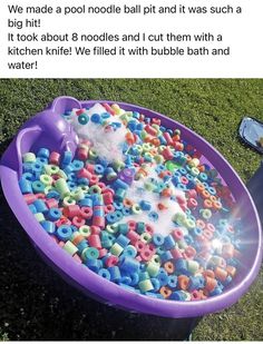 a large purple bowl filled with lots of beads and sprinkles on the ground