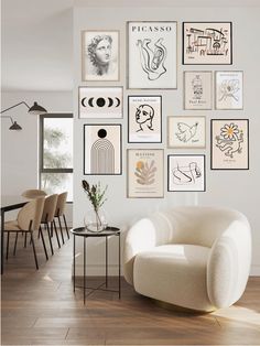 a white chair sitting in front of a wall filled with pictures on it's side