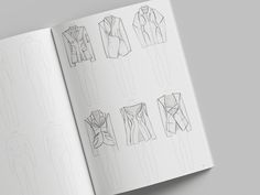 an open book with drawings of different types of jackets and shirts on the pages,