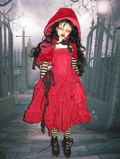 a creepy doll dressed in red and black