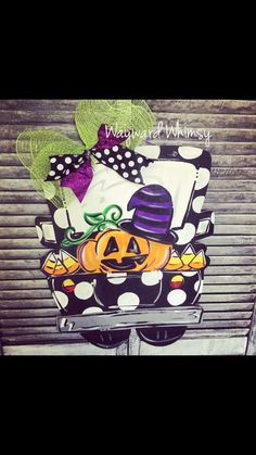 a car decorated for halloween with pumpkins and hats