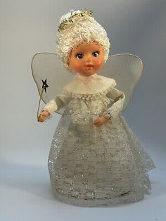 a glass angel figurine holding a star