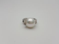 This elegant and timeless pearl and diamond white gold ring are a must-have in a woman's wardrobe. It goes perfectly with almost anything Great gift for a young lady Beautiful real Australian South sea pearl with real diamonds The pearl is white rose color, smooth and shiny with high luster White diamonds H/VS Hand made * genuine South Sea cultured pearl * 13.7 mm in diameter * round in shape * very high luster * grade AAA * 18K White gold * 0.30 carats total weight of real diamonds * quality H Luxury White Pearl Ring With Single Cut Diamonds, Hallmarked White Pearl Ring Fine Jewelry, Luxury Exquisite Akoya Pearl Rings, Luxury Pearl White Round Pearl Ring, Luxury Tahitian Pearl Ring, Round Shape, Japanese Pearls, Beautiful Pearl Necklace, Real Diamond Rings, Pearl And Diamond Ring