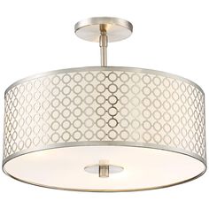 a light fixture with a circular design on the top and white fabric covering over it