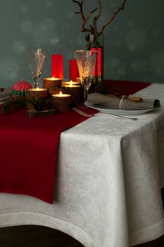 the table is set with candles and dishes