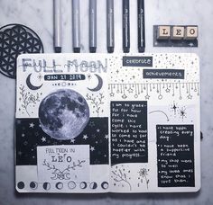 an open notebook with writing on it and various stickers around the pages that include drawings