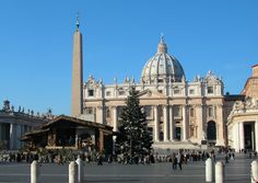 people are walking around in front of a large building