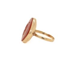 A fine antique intaglio ring.  Likely converted from an antique button or pin.  In 14k gold  With a carved carnelian cabochon depicting an unidentified Roman hero.  Marked 14k to the shank.  Simply a wonderful intaglio ring!  Date: some parts 20th Century, remainder possibly earlier.  Overall Condition: It is in overall good, as-pictured, used estate condition.   Condition Details: There is some light denting to the bezel setting. Otherwise, there is some light edge wear, some fine and light sur Antique Carnelian Intaglio Rings, Vintage Carnelian Signet Ring, Vintage Oval Carnelian Signet Ring, Vintage Carnelian Yellow Gold Ring, Vintage Yellow Gold Carnelian Ring, Vintage Carnelian Signet Ring For Formal Occasions, Formal Carnelian Cameo Jewelry, Formal Cameo Carnelian Jewelry, Formal Cameo Jewelry In Carnelian