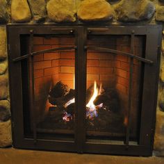 a fire is burning in a stone fireplace