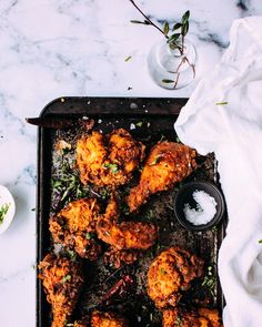 chicken wings on a baking sheet with herbs and salt