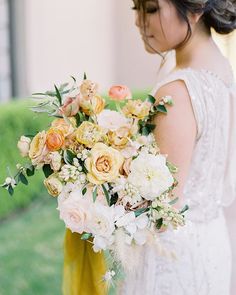 a woman holding a bouquet of flowers in her hands