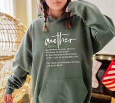 Mother Noun Hoodie, Mom Life Hoodie, Cute Mom Hoodie, Mothers Day Gift, Mother's Day Hoodie,Mama Hoodie,New Mom Gift,Trendy Mom Hoodie   PRODUCT DETAILS 💫Youth Hoodies do not have drawcord for added safety💫 - Our hoodies are made for comfort with a 50% cotton and 50% polyester blend. - They're built to last with a medium-heavy fabric  (8.0 oz/yd² (271 g/m - Enjoy a relaxed fit and a sewn-in label. - Get the right size with our true-to-size guide.   SIZING - Find your perfect fit in our size ch Cotton Hooded Hoodie For Mother's Day, Mother's Day Hooded Hoodie With Letter Print, Long Sleeve Hoodie With Letter Print For Mother's Day, Mama Hoodie, Hoodie Cute, Trendy Mom, Mom Hoodies, Business Checks, New Mom Gift