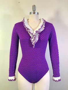 Cute as hell ruffle collared polka dot bodysuit by Radlee, from the late 1960s / early 1970s.  70% stretch nylon, 30% stretch polyester, with 3 snap closures. Says size M on tag but fits like an XS/S. Very small stain on ruffled collar (as pictured) but otherwise in very good vintage condition. Across shoulders: 15" Waist: 12.5" Length: 26" Fitted Long Sleeve Bodysuit With Ruffles, Retro Fitted Bodysuit For Party, Late 1960s, Ruffled Collar, Ruffle Collar, Womens Bodysuit, Catsuit, Snap Button, Polka Dot