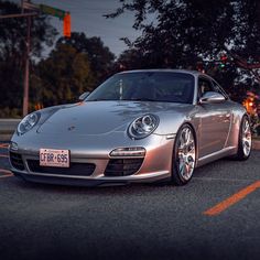 a silver sports car is parked on the street