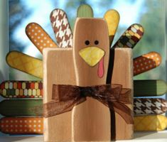 a wooden turkey decoration sitting on top of a window sill