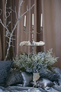 a table topped with a cake covered in frosting next to two candelabras