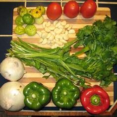 various vegetables are on a cutting board ready to be cooked