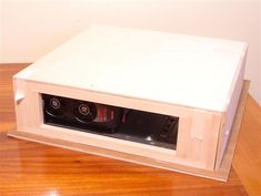 a white box sitting on top of a wooden table