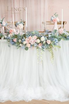 a table with flowers and candles on it