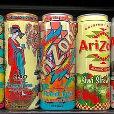 six cans of various flavored beverages on display in a store shelf, all different colors and flavors