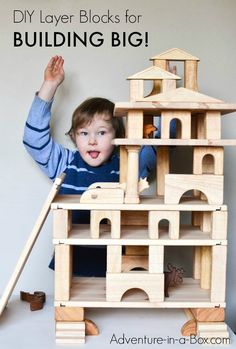 a young boy playing with a wooden building set