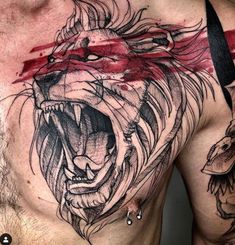 a man's chest with a lion tattoo on it