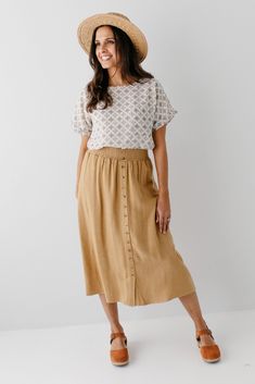 Start your day in style with the 'Greta' Skirt! This midi length, linen-blend skirt is light and airy for spring and summer and features button-down detailing for a fun touch. Pair the 'Greta' with all your favorite tops for Sunday morning or a day at the farmer's market! 30% Linen 70% Rayon Hand Wash Cold Hang to Dry Low Iron if Needed Do Not Dry Clean Fully Lined Model in Ochre Height 5'5" | Wearing Size Small Wearing 'Shalom' Geometric Print Top in Tan & 'Greta' Linen Blend Midi Skirt in Ochr Layered Tops, Farmer's Market, Low Iron, Skirt Leggings, Sunday Morning, Spring Collection, Blouse Dress, Tops For Leggings, Print Top