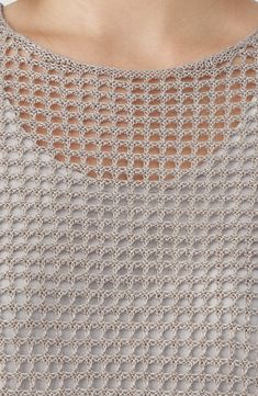 a close up view of the back of a woman's top with an openwork design