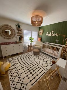 a baby's room with green walls, white furniture and a giraffe rug