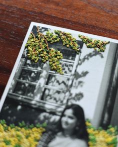 an old photo is sitting on a wooden table