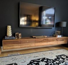 a large television mounted to the side of a wooden entertainment center in a living room