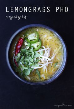 a bowl filled with soup and vegetables on top of a black table next to the words lemongrass pho