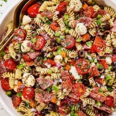 a bowl filled with pasta salad on top of a table