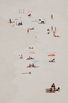 many people are on the beach with umbrellas in the sand and one person is laying down