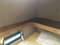 the bed is made up and ready for someone to use it in their camper