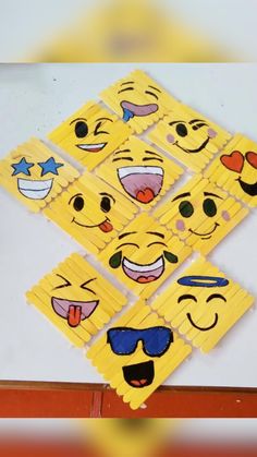 several pieces of yellow cardboard with different emoticions on them and one has sunglasses