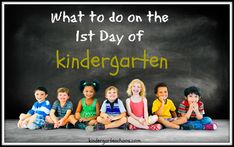 a group of children sitting next to each other in front of a chalkboard