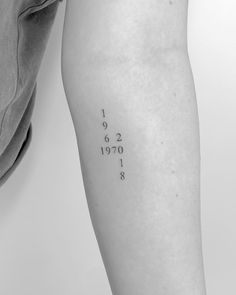 a woman's leg with numbers on it and the word date tattooed in black ink