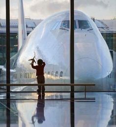 a small child standing in front of an airplane